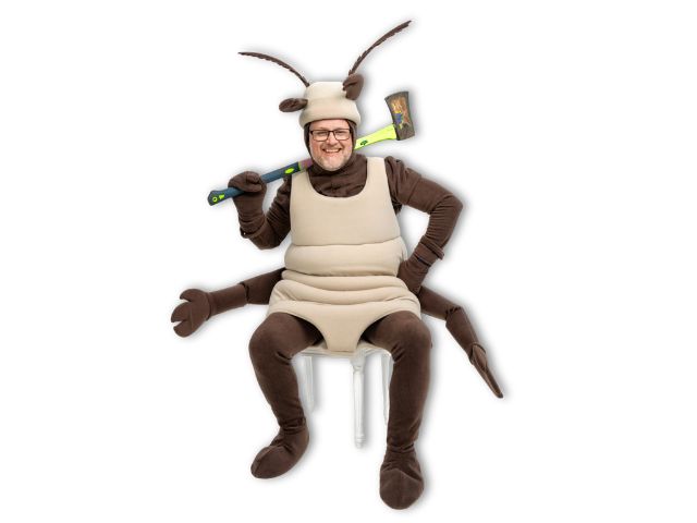 Photo of Adam on a chair with an axe in a termite costume
