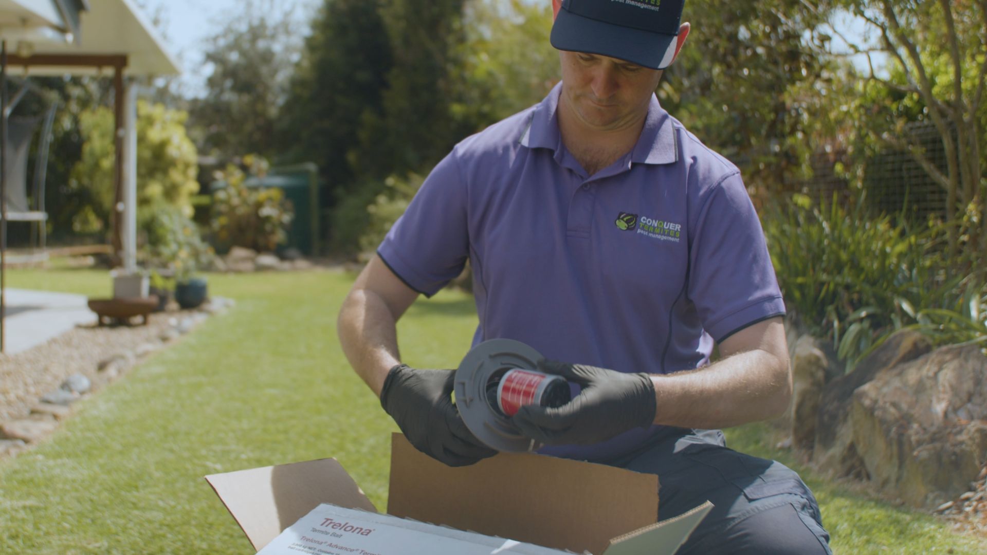 Conquer Termite technician installing BASF Trelona in-ground bait station